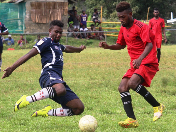 F-Ridge player in blue tries to clear the ball from Central Coast FC attacking player in Red.Picture By Wilson Saeni