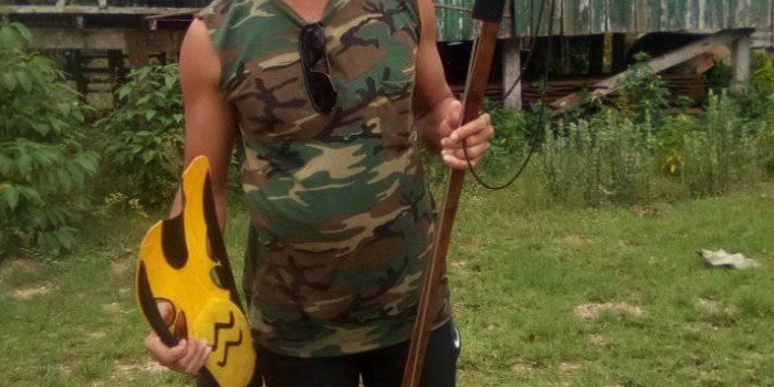 One of the divers Jeffery Henry hold a flipper and diving gun of the missing boy after recovering them beneath the sea. Photo Supplied