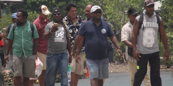 FRONT PAGE_MPAs walking at the back of their bodyguards on their arrival at Auki Wharf