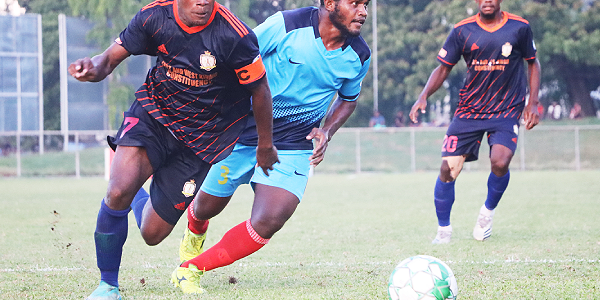 Micah Lealafa of Waneagu FC edges past Collin Lokata, Isabel FC defender.