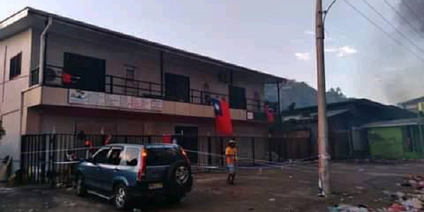 A full-length Taiwanese flag flying on this building in Chinatown while shops around it were burning