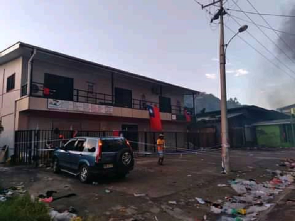 A full-length Taiwanese flag flying on this building in Chinatown while shops around it were burning