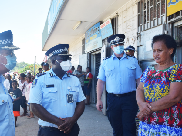AC Pogeava and AFP officers chat with a member of the community.