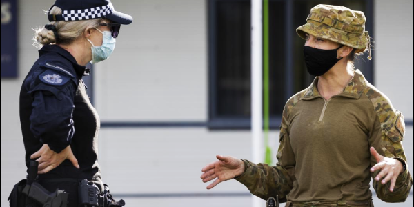 Australian Army Captain Celie Bright-Perry speaks with an AFP health planner during their deployment to Solomon Islands. Photo, Corporal Brandon Grey.