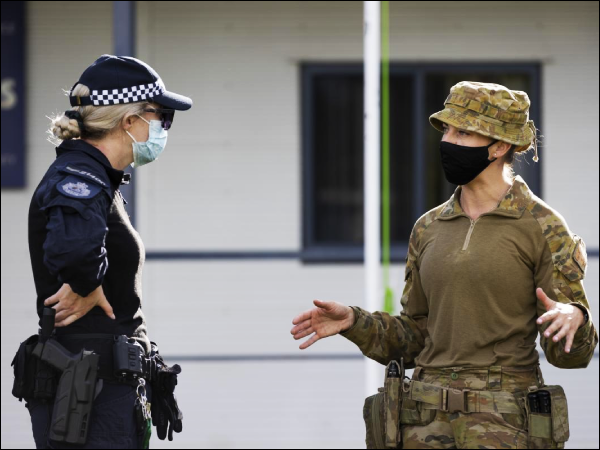 Australian Army Captain Celie Bright-Perry speaks with an AFP health planner during their deployment to Solomon Islands. Photo, Corporal Brandon Grey.