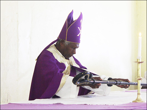 The Right Reverend Bishop Ben Seka laying down the Pastoral staff on the Alter. Photo: ACOM.