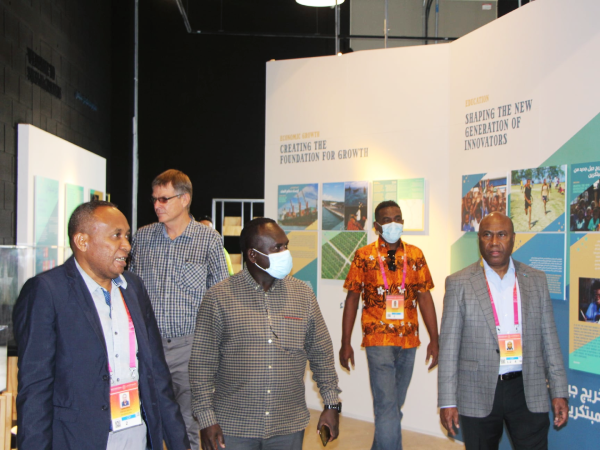 Solomon Islands Deputy Commissioner General (DCG) Dennis Marita giving the delegation consisting of Government and Private Sector Officials a tour of the Solomon Island Pavilion.