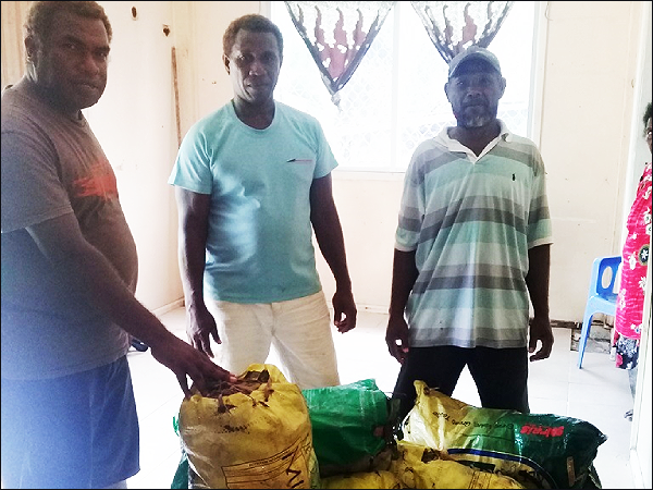 Farmers and Goshen Enterprise workers with their bags of taro supply upon their arrival in Auki this week