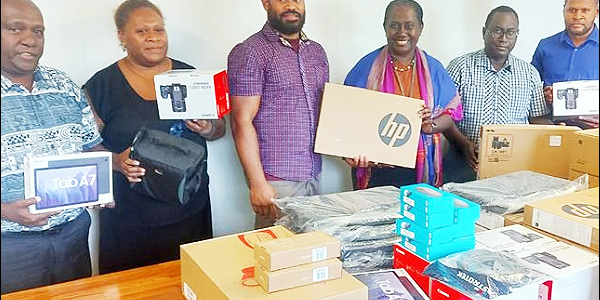 Ministry of Health officials with the donation of A/V equipment donated by the Pacific Community (SPC), including tablets, laptops, multimedia projectors, cameras, video conferencing material, and smart monitors.