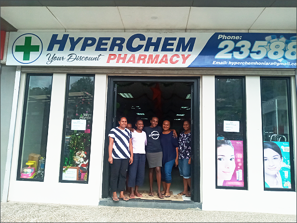 Staff of the HyperChem Pharmacy at the entrance the shop.