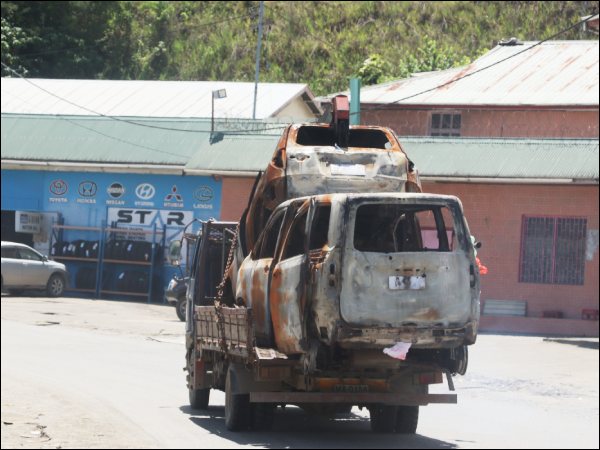 A truck transporting burned cars from Chinatown.
