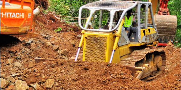 Bulldozer clearing the road for Pacific Nickel’s new campsite on Isabel
