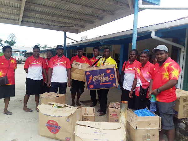 B.H.P team members pose with the box of gifts ready to be distributed to sick patients at Kiluufi hospital.