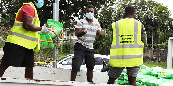 Livelihood distribution team members loading an RSIPF a three-ton truck with food supplies to be delivered to the RSIPF affected families at the LSC operation Centre, Friday.