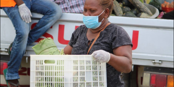 Rose Ama of the Mobile Market serving a customer.