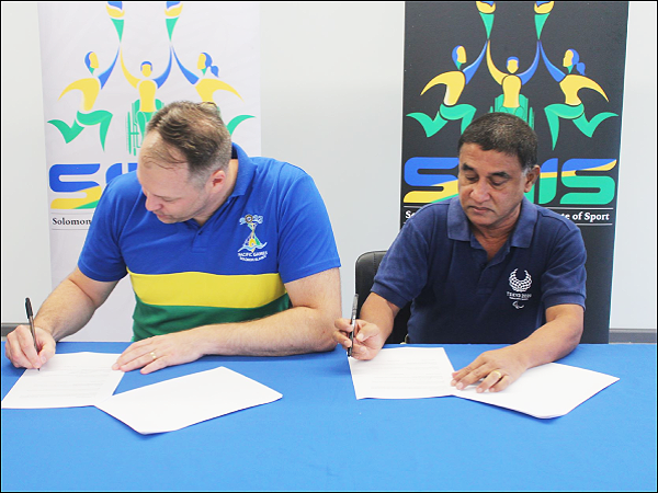 SINIS High – Performance Executive Director Aaron Alsop and Solomon Islands National Paralympic Committee (SINPC) President Nihal Seneviratne signing the MOU on Friday
