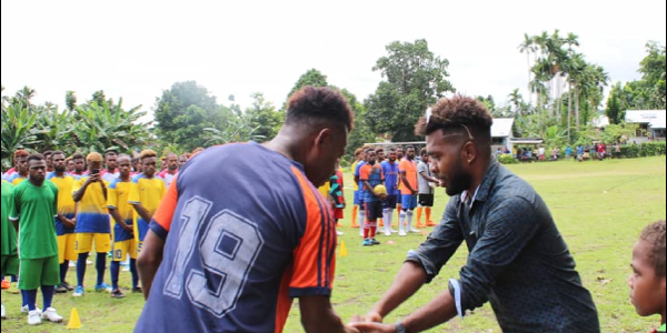 Team Captain of the reigning champions Mr. James Lapoe of Lata united FC shaking hands with the Tournament’s Patron.