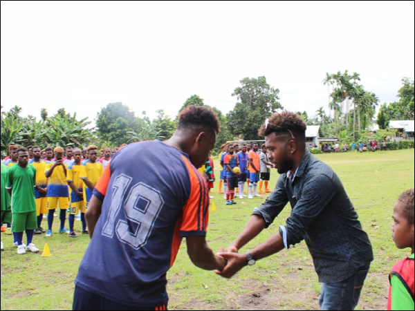 Team Captain of the reigning champions Mr. James Lapoe of Lata united FC shaking hands with the Tournament’s Patron.
