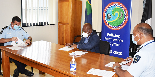Commissioner of Police (R), Honorable Minister Anthony Veke (C) and Commander Paul Osborne (L) signing the MoU. (Photo supplied)