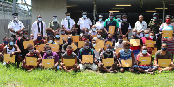 Commissioner Manelusi and his executive with the thirty five early released inmates.