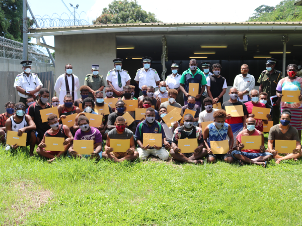 Commissioner Manelusi and his executive with the thirty five early released inmates.