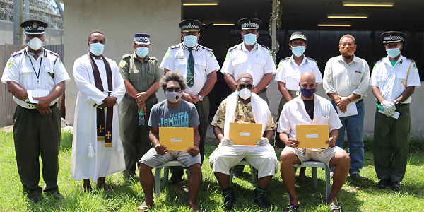 Commissioner and his executive with the three parolees. Photo supplied.