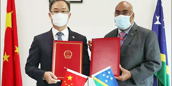 Chinese Ambassador His Excellency LI Ming and the Permanent Secretary of the Ministry of Foreign Affairs and External Trade, Colin Beck, displaying the signed the Framework Agreement. Photo: Supplied.