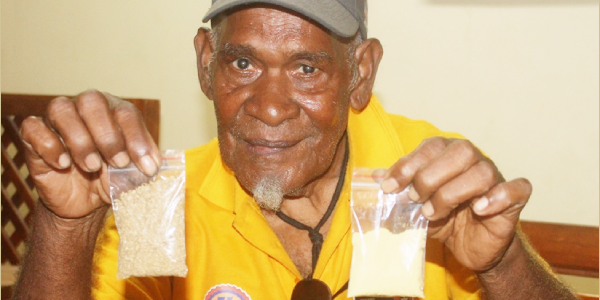 Local Ginger farmer, Felix Laumae showing samples of his ginger powder products.