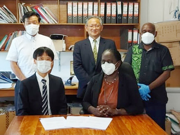 Mrs. Pauline McNeil, Health PS and Mr. Hiraoka Hisakazu, Leader of the Preparatory Survey Team of JICA (sitting) during the signing last week.