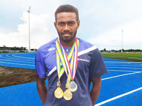 Leeroy Alulu showing his three medals.
