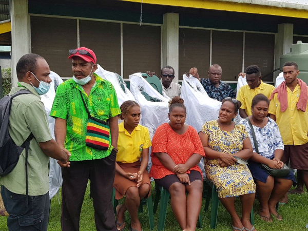 Staff and students of Honiara High School receiving the chairs.