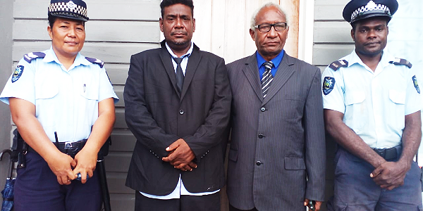 Premier Galaigu and the Speaker Honorable Moah flanked by two Police Officers after the declaration of his premiership in Tulagi, Wednesday.