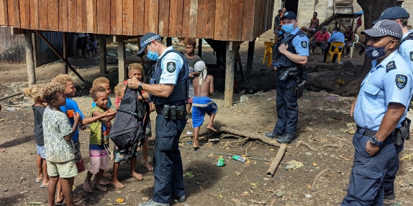 AFP officers under SIAF and RSIPF officers interacting with children of Koa Hill community.