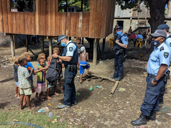 AFP officers under SIAF and RSIPF officers interacting with children of Koa Hill community.