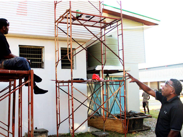 Hon. Alfred Efona, MP visits construction workers on site to see the progress. Photo supplied.