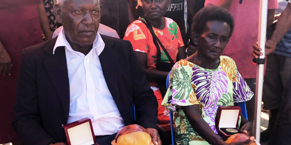 John Koloni and Nelma Ane Biuku with the medallion and the replicated coconuts where John F Kennedy wrote a letter to US Marines who based on Lubaria Island in North Rendova. Photo Lachlan Eddie.