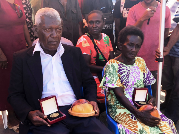 John Koloni and Nelma Ane Biuku with the medallion and the replicated coconuts where John F Kennedy wrote a letter to US Marines who based on Lubaria Island in North Rendova. Photo Lachlan Eddie.