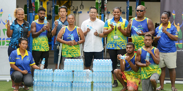Blue Water reps handing over bottles of water to the Para-athletes.