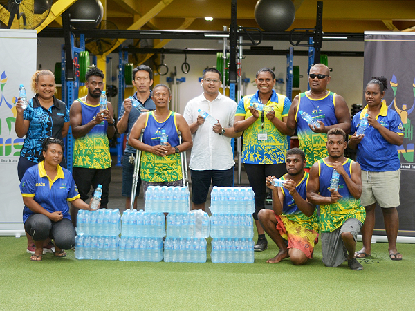 Blue Water reps handing over bottles of water to the Para-athletes.