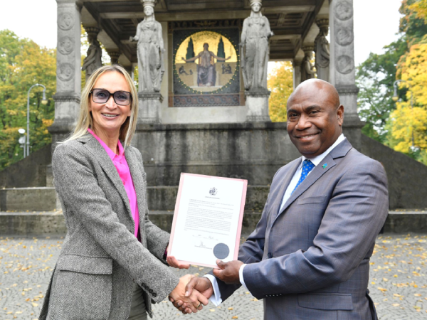 Solomon Islands Ambassador to the European Union, Moses Mose, right, officiating the appointment of Dr Claudia Seutter von Lötzen as the Honorary consul of Solomon Islands to Germany.