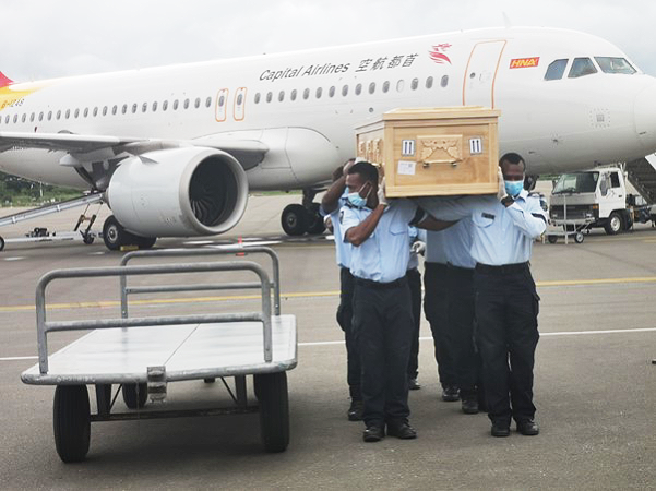 Ambassador Fugui’s casket being carried off the plane.