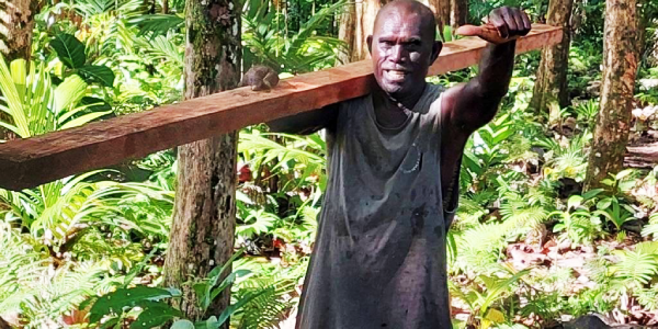 One of the hardworking elderly man carrying timbers for the hall. Photo DAMI Photographer&Film