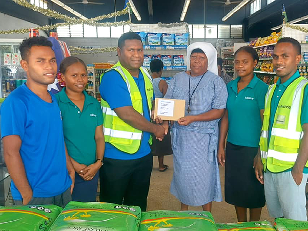A Sister of the CCC receives the donations from the Bulkshop staff at Point Cruz.