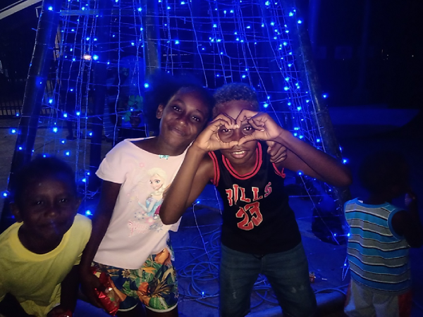 Three kids enjoying the lights at Gizo.