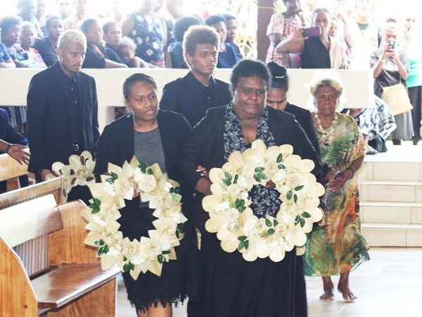 Wife of the Late Ambassador, Mrs Jane Fugui, and her children proceed to lay their wreaths during the official funeral program. Photo, OPMC.