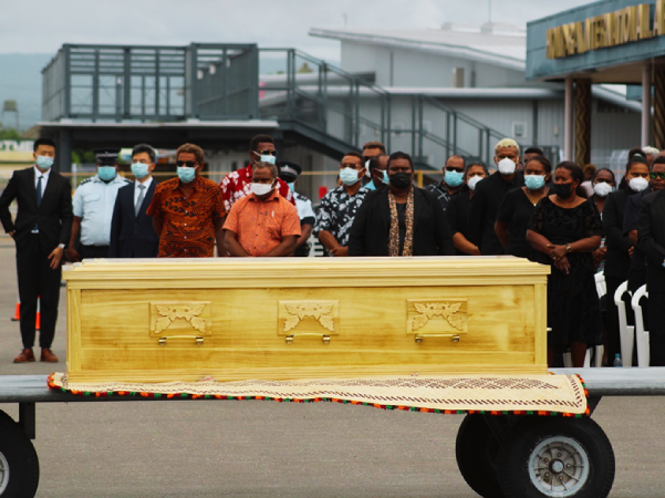 The casket of the late Ambassador lies in front of family and government officials after being flown into the country from China on Tuesday.