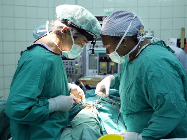 An interplast team doctor and a NRH doctor operating on a patient back in 2015. Photo, AHC.