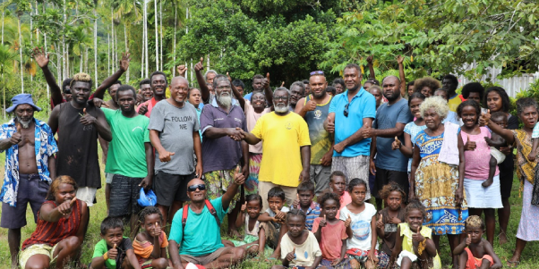 Pastor Linus Siso and Community Chief Masolo Piduru shake hands to depicts that all the ill feelings and differences now water under the bridge flanked by MP Chachabule, MRD officials and elated community members.