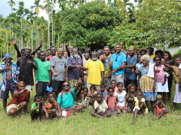 Pastor Linus Siso and Community Chief Masolo Piduru shake hands to depicts that all the ill feelings and differences now water under the bridge flanked by MP Chachabule, MRD officials and elated community members.