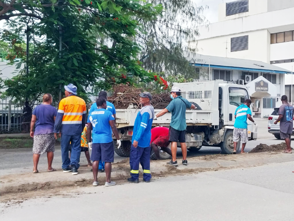 Some members of the group collecting rubbish along Mendana Avenue.